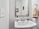 Bathroom featuring a pedestal sink, mirror, and stylish towel rack at 200 Oakside Way, Lawrenceville, GA 30046