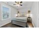 Bright bedroom features a ceiling fan, beautiful hardwood floors and a light blue comforter at 200 Oakside Way, Lawrenceville, GA 30046