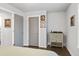 Neutral bedroom features hardwood floors, two gray doors, and a wooden cabinet at 200 Oakside Way, Lawrenceville, GA 30046