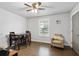 Bedroom with hardwood floors, a ceiling fan, a dining table, and an armchair at 200 Oakside Way, Lawrenceville, GA 30046