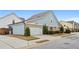 Charming, light blue two-story home featuring an attached two-car garage and manicured landscaping at 200 Oakside Way, Lawrenceville, GA 30046