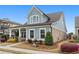 Charming home featuring blue siding and brick accents, complemented by lush landscaping in a welcoming setting at 200 Oakside Way, Lawrenceville, GA 30046