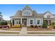 Charming home with blue siding, a covered porch with seating, and well-maintained landscaping at 200 Oakside Way, Lawrenceville, GA 30046