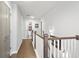 Upstairs hallway features wooden floors, white walls and access to the main bathroom at 200 Oakside Way, Lawrenceville, GA 30046