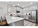Well-lit kitchen with stainless steel appliances, quartz countertops, and stylish backsplash at 200 Oakside Way, Lawrenceville, GA 30046