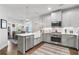 Open kitchen with stainless steel appliances and an island, flowing into the dining area at 200 Oakside Way, Lawrenceville, GA 30046
