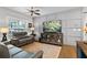 Cozy living room featuring a comfortable leather sofa, entertainment center, and stylish decor at 200 Oakside Way, Lawrenceville, GA 30046
