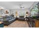 Well-lit living room with hardwood floors, comfortable seating, a fireplace, and entertainment center at 200 Oakside Way, Lawrenceville, GA 30046
