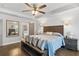 Comfortable main bedroom features a ceiling fan, hardwood floors and access to the main bathroom at 200 Oakside Way, Lawrenceville, GA 30046