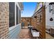 Enclosed outdoor patio with brick flooring, wood privacy screen, and comfortable seating area at 200 Oakside Way, Lawrenceville, GA 30046
