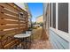 Private brick patio featuring a metal table and chair set and a wooden privacy fence at 200 Oakside Way, Lawrenceville, GA 30046