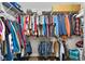 Walk-in closet with ample hanging space for clothes, shoes, and accessories at 200 Oakside Way, Lawrenceville, GA 30046