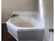 Bathroom featuring a bright white corner bathtub at 2076 Dobbins Nw Dr, Kennesaw, GA 30144