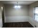 A dining room with a chandelier, white wainscoting and hardwood flooring at 2076 Dobbins Nw Dr, Kennesaw, GA 30144