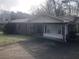 Traditional brick home featuring a covered entry and adjacent carport at 2076 Dobbins Nw Dr, Kennesaw, GA 30144