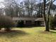 Charming brick ranch-style home with a well-maintained lawn and mature trees providing shade at 2076 Dobbins Nw Dr, Kennesaw, GA 30144