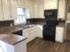 Well-lit kitchen showcasing white cabinetry, updated appliances, and new looking floors at 2076 Dobbins Nw Dr, Kennesaw, GA 30144