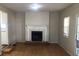 Cozy living room featuring a traditional fireplace and hardwood flooring at 2076 Dobbins Nw Dr, Kennesaw, GA 30144