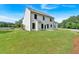 A large, grassy backyard view of the exterior of a two-story white home at 380 Waterbluff Dr, Mableton, GA 30126