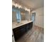 Bathroom featuring double sink vanity, wood-look flooring, and ample lighting at 380 Waterbluff Dr, Mableton, GA 30126