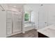 Bright bathroom featuring glass shower, tub and vanity with sink and hard wood flooring at 380 Waterbluff Dr, Mableton, GA 30126