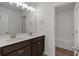 Bathroom featuring double vanity, dark cabinets, and a view of the shower/tub at 380 Waterbluff Dr, Mableton, GA 30126