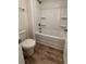 Clean bathroom features a white tub and shower combination with built-in shelves at 380 Waterbluff Dr, Mableton, GA 30126