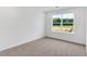 This bedroom features a window, gray carpet, and white walls at 380 Waterbluff Dr, Mableton, GA 30126
