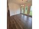 Light dining room with hardwood floors, decorative molding, and a modern chandelier at 380 Waterbluff Dr, Mableton, GA 30126