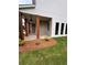 Side view of a home with a covered porch, wood columns, brick accents, and lush landscaping at 380 Waterbluff Dr, Mableton, GA 30126