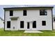 Rear exterior view of a home with white siding, black trim, and a small patio at 380 Waterbluff Dr, Mableton, GA 30126