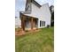 Angle view of a home with a covered porch, wood columns, brick accents, and lush landscaping at 380 Waterbluff Dr, Mableton, GA 30126
