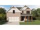 Charming brick two-story home with a two-car garage, covered porch, and manicured lawn at 380 Waterbluff Dr, Mableton, GA 30126