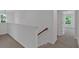 Hallway on second floor with decorative light fixture and access to bedrooms through white doors at 380 Waterbluff Dr, Mableton, GA 30126