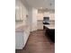 Modern kitchen with white cabinets, granite countertops, stainless steel appliances, and hardwood floors at 380 Waterbluff Dr, Mableton, GA 30126