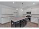 Modern kitchen featuring an island, granite counters, stainless steel appliances, and stylish pendant lighting at 380 Waterbluff Dr, Mableton, GA 30126