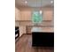 Bright kitchen with white cabinets, granite countertops, stainless steel appliances, and view to backyard at 380 Waterbluff Dr, Mableton, GA 30126