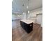 Open kitchen layout with granite countertops, large island, and hardwood floors at 380 Waterbluff Dr, Mableton, GA 30126