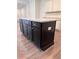The dark kitchen island features a light countertop and ample storage space at 380 Waterbluff Dr, Mableton, GA 30126
