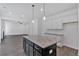 Stylish kitchen island with granite countertop and pendant lighting, seamlessly connected to the living area at 380 Waterbluff Dr, Mableton, GA 30126