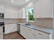 Bright kitchen with white cabinets, granite countertops, stainless steel appliances and a large window at 380 Waterbluff Dr, Mableton, GA 30126