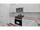 Close up on stainless steel oven and cooktop next to subway tile backsplash and lots of counterspace at 380 Waterbluff Dr, Mableton, GA 30126