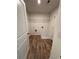 Bright laundry room with wood-look flooring and wire shelving at 380 Waterbluff Dr, Mableton, GA 30126