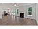 Open-concept living room with fireplace, hardwood floors, and abundant natural light at 380 Waterbluff Dr, Mableton, GA 30126