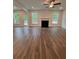 Open-concept living room with fireplace, ceiling fan, hardwood floors, and natural light at 380 Waterbluff Dr, Mableton, GA 30126