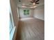 Main bedroom suite with natural light, tray ceiling, and neutral colored carpet at 380 Waterbluff Dr, Mableton, GA 30126
