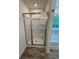 Bathroom featuring glass-enclosed shower, and wood-look flooring at 380 Waterbluff Dr, Mableton, GA 30126