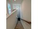 Carpeted stairway ascending to the upper level of the home with natural light at 380 Waterbluff Dr, Mableton, GA 30126