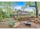 Beautiful backyard with a fire pit, lush landscaping, and a spacious patio for outdoor enjoyment at 3951 Lorien Nw Way, Kennesaw, GA 30152