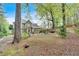 Green backyard features a patio, firepit, and an expansive lawn at 3951 Lorien Nw Way, Kennesaw, GA 30152